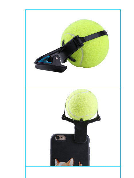 Tennis ball with a clip attached to a phone case on a white background