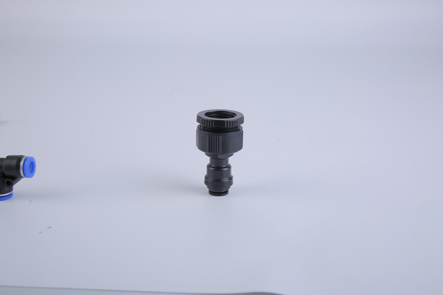 Black and blue plumbing fitting on a white background