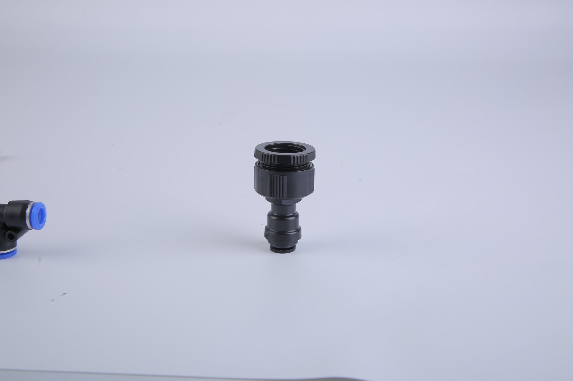 Black and blue plumbing fitting on a white background