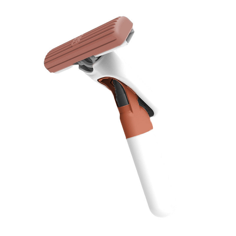 Cleaning tool with brown scrubber and white handle on a white background