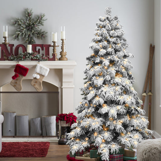 Frosted Christmas tree with lights in a living room setting.