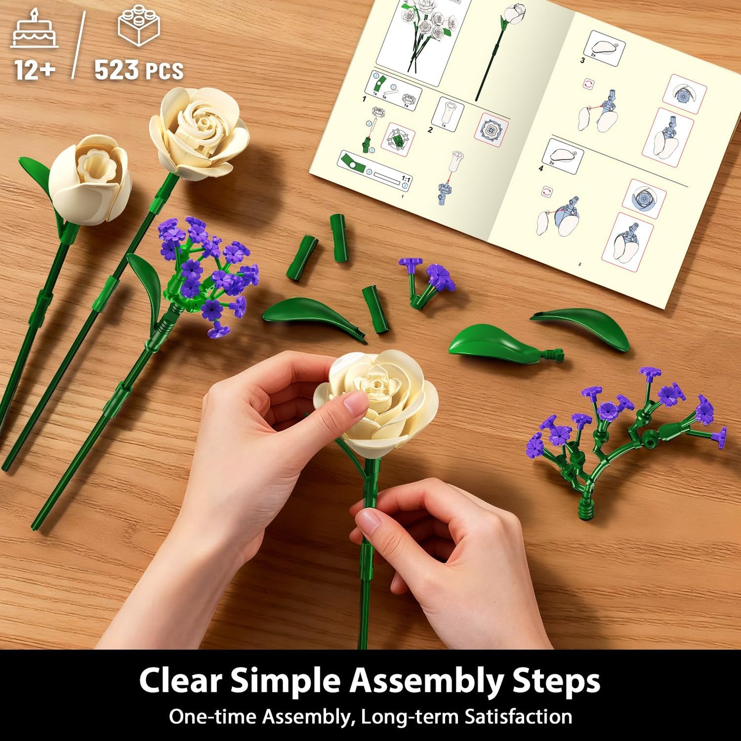 Hands assembling a floral model kit on a wooden surface with an instruction manual.