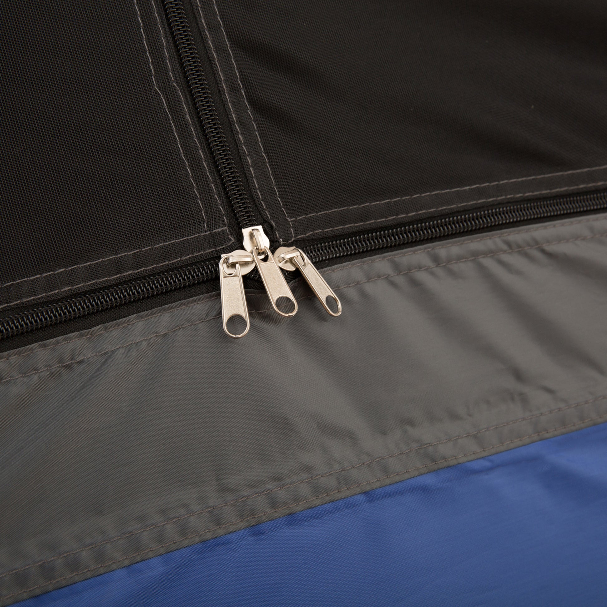 Close-up of a zipper on a black and blue fabric surface
