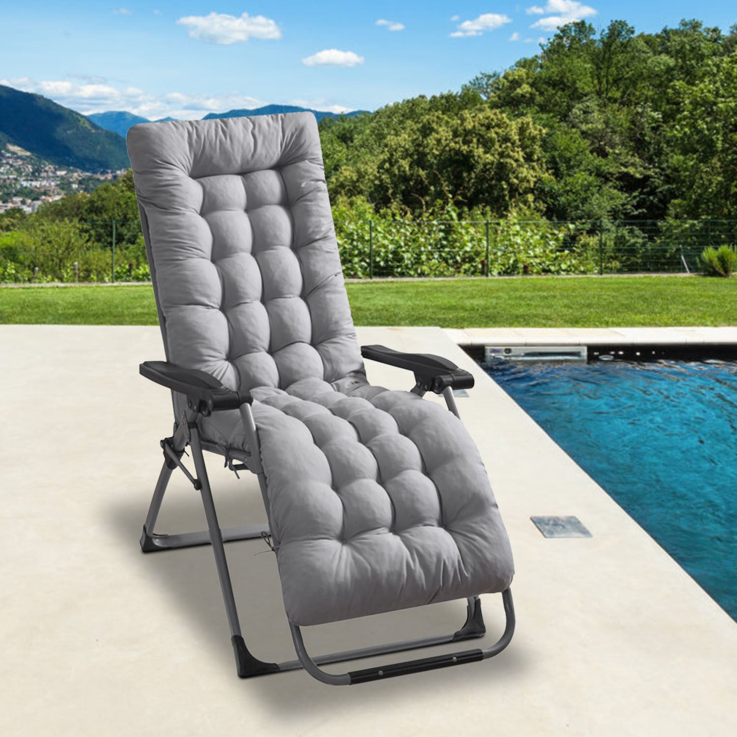 Gray lounge chair by a pool with a scenic background