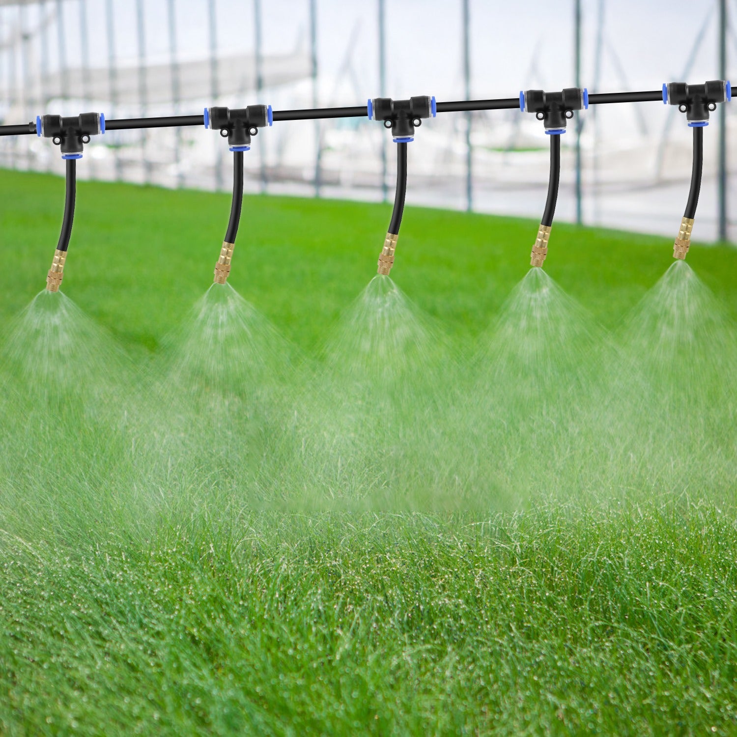Sprinkler system watering a green lawn with a blurred background