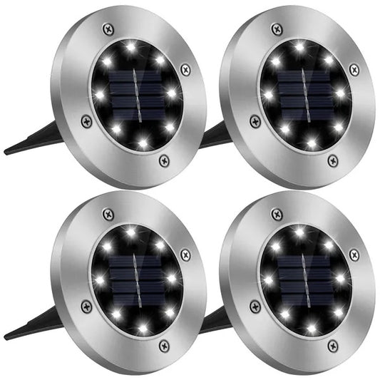 Four solar-powered outdoor lights on a white background