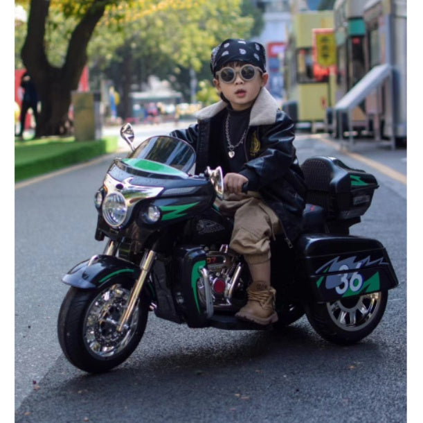 Child sitting on a toy motorcycle on a street