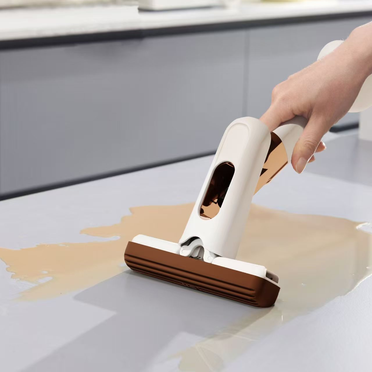 Person using a handheld vacuum cleaner to clean a spill on a surface.