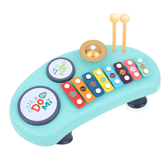 Colorful toy piano with buttons and mallets on a white background